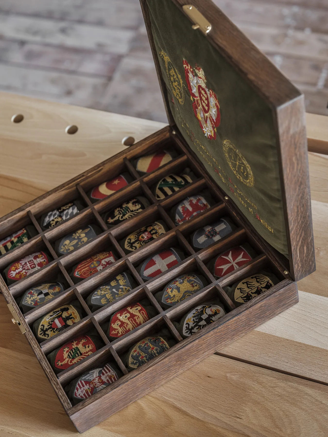 The finished oak chest, opened to show the velvet lining and heraldic cushions
