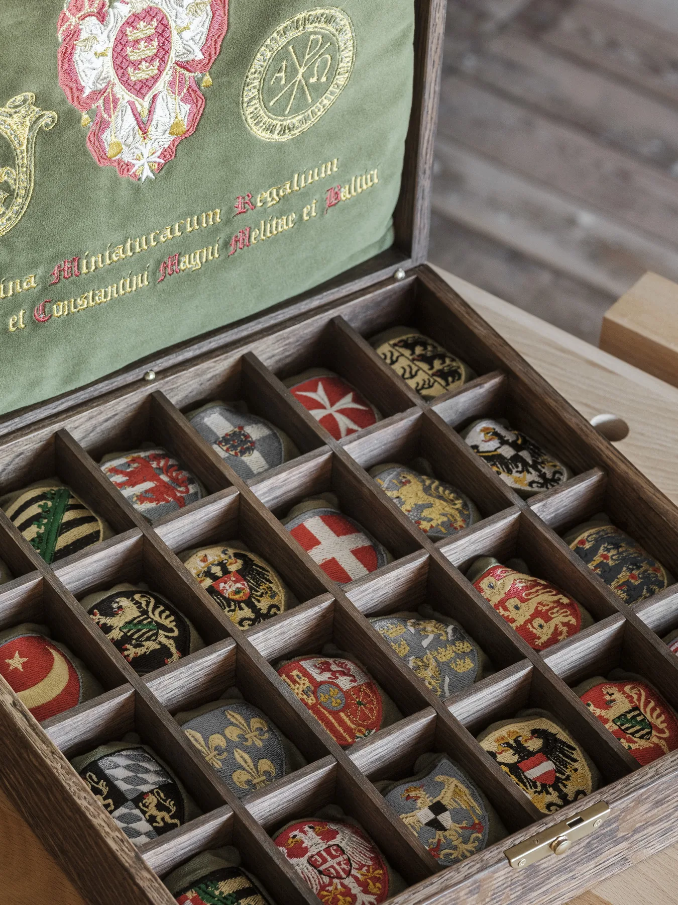 Hand-embroidered heraldic cushions in their oak compartments