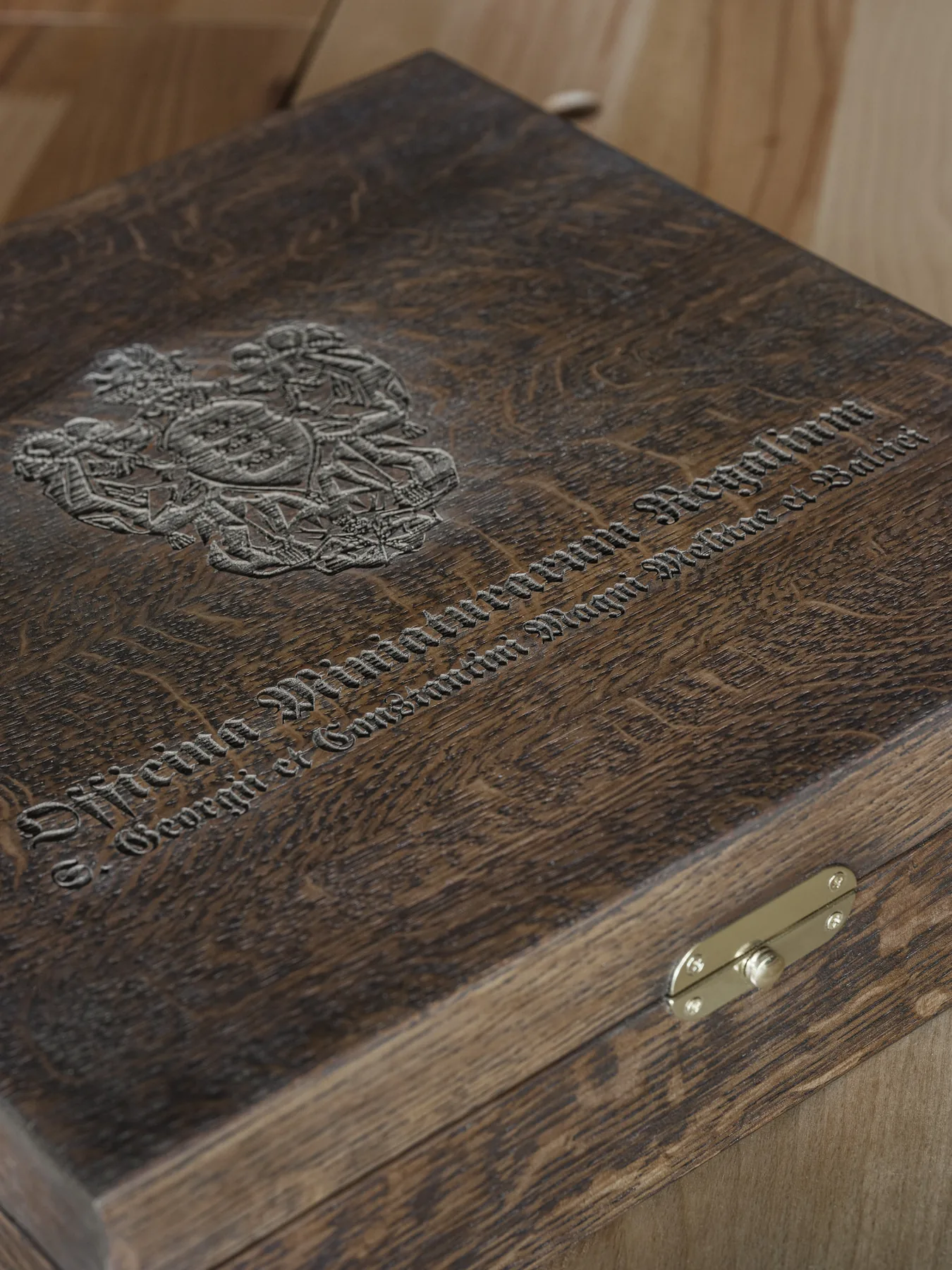 Studio arms engraved on the oak lid of the chest
