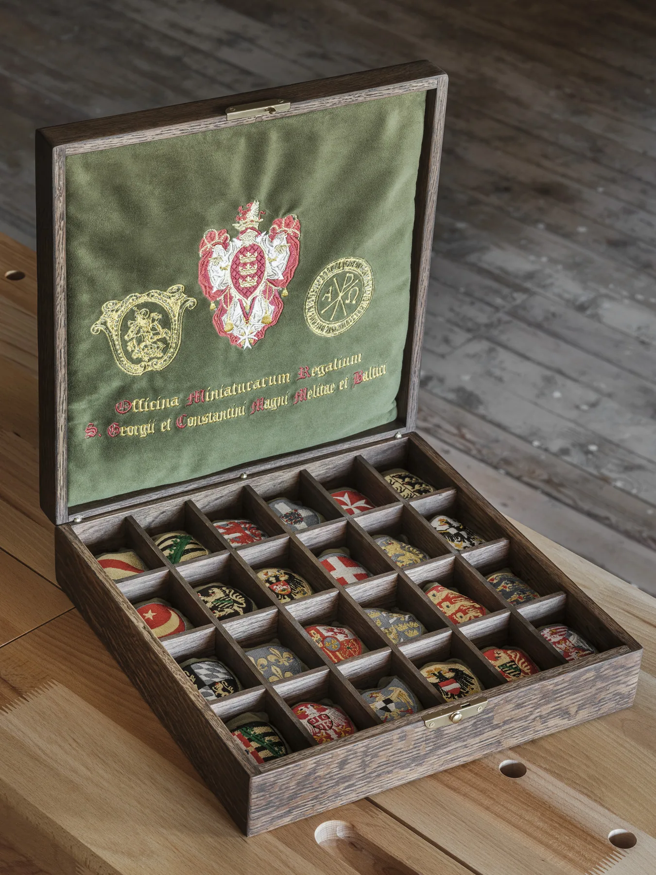 Solid oak collector's chest lined with green velvet, with hand-embroidered heraldic cushions