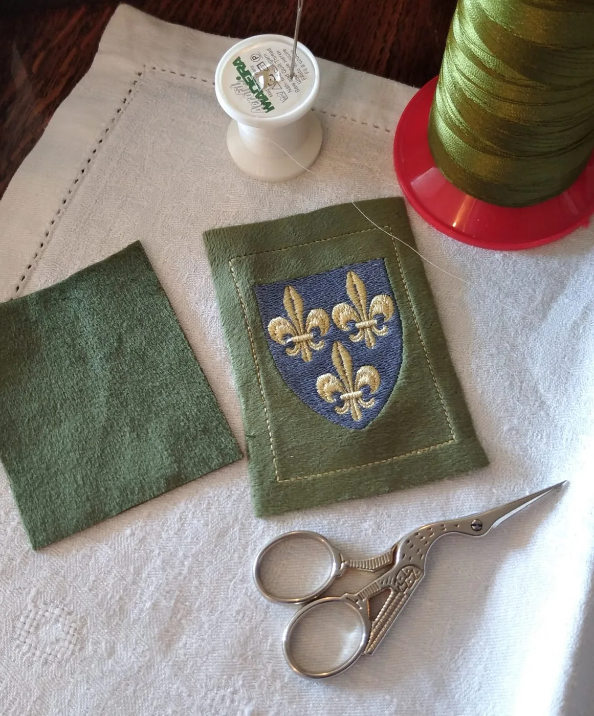 Embroidering a heraldic cushion with the royal arms of France